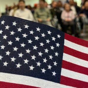 USCIS office building with American flag representing stricter immigration reviews and application delays