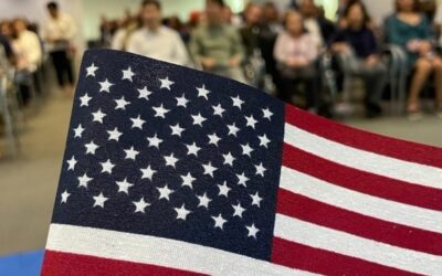USCIS office building with American flag representing stricter immigration reviews and application delays
