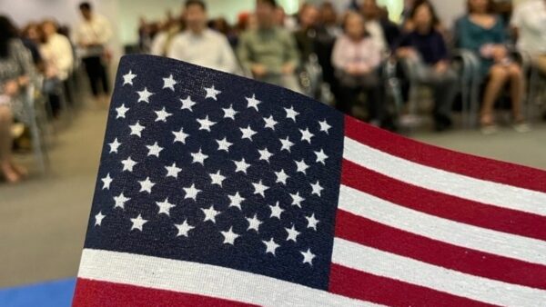 USCIS office building with American flag representing stricter immigration reviews and application delays