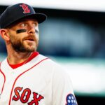 New York Yankees and Boston Red Sox players face off at Fenway Park during an MLB game